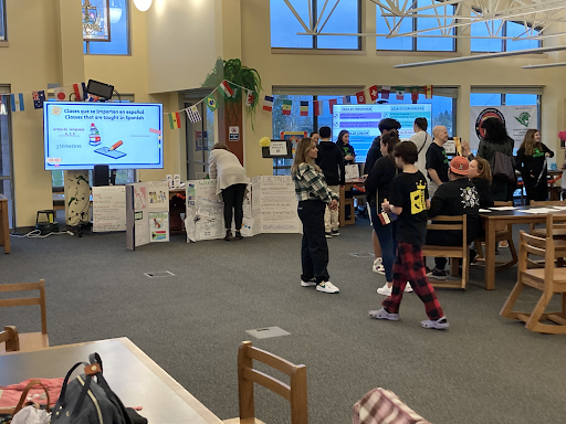 A large group of people gather in the library during the Dual Language program family night on Mar 12, 2024 at West Salem High School in Salem, OR. 